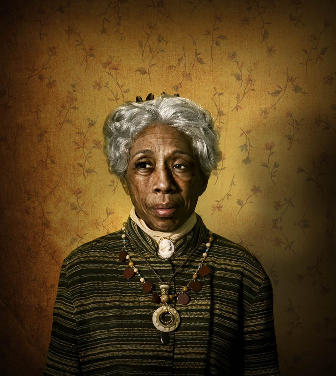 Aunt Esther, a chracter from AUgust WIlson's cycle of plays is portrayed as an old black woman with gray hair, exotic necklaces, and modest, timeless dress with a cameo broach at her throat.