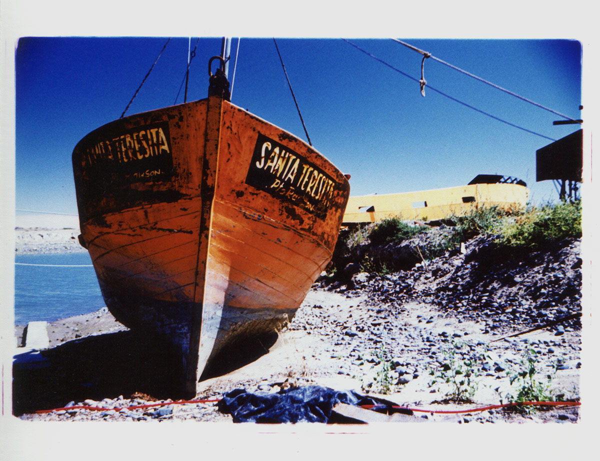 The fishing boat Santa Teresita sits on dry land at a boatyard outside Puerto Madryn, Argentina. Cross Process.