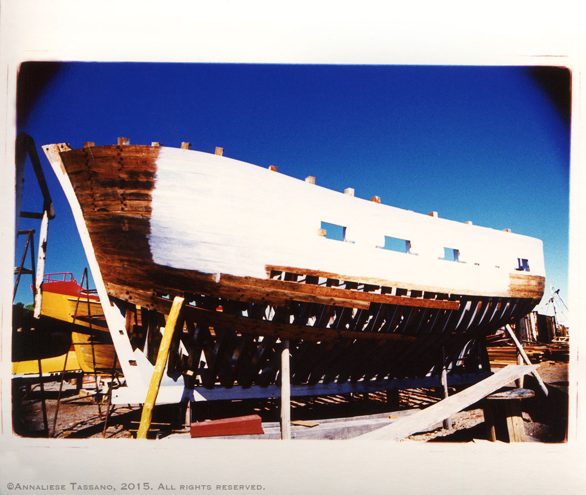 A cross process image shows traditional techniques used to build awooden fishing boat. It wits braced in a boatyard outside Puerto Madryn, Argentina.