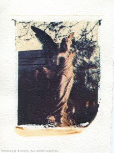 A broken stone cemetery angel in Kensall Green Cemetery. Polaroid transfer.