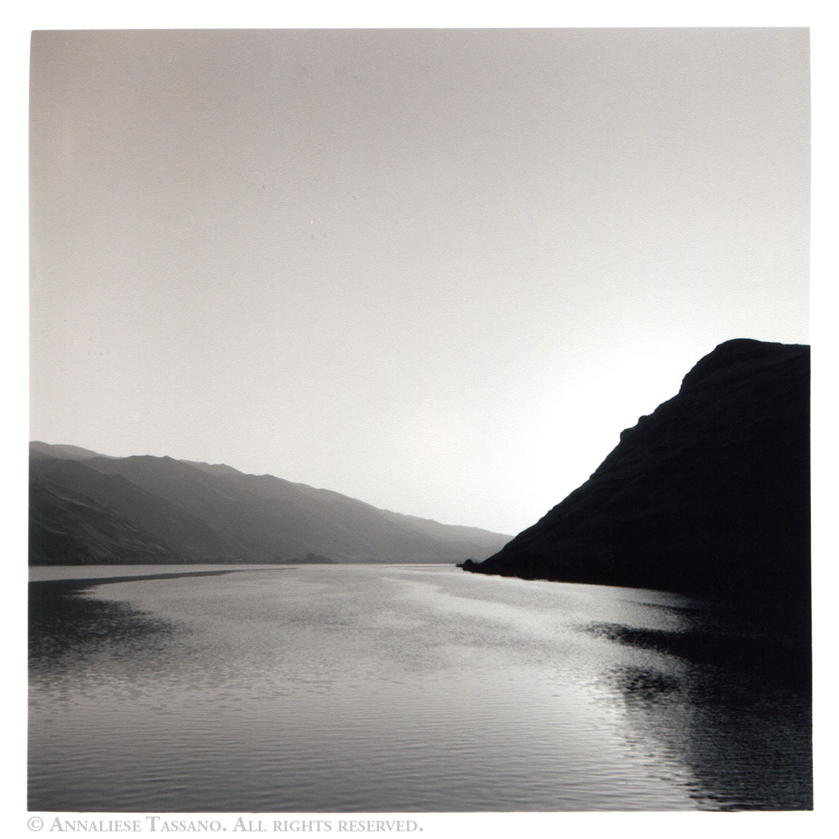 A black and white view of the Columbia river, flowing between Oregon and Washington at Sunset.