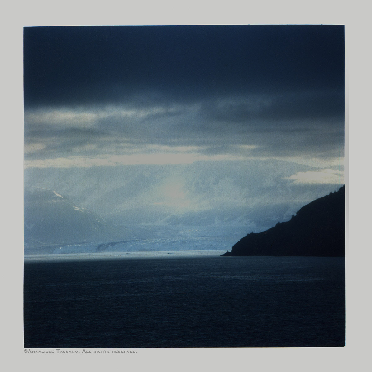 Wind blowing off the glacier, keeping Glacier Bay in Alaska sunny beyond the clouds.