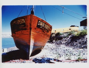 The fishing boat Santa Teresita sits on dry land at a boatyard outside Puerto Madryn, Argentina. Cross Process.